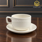 ivory white cup and saucer, classic tea cup, minimalist crockery, wooden table setting, Sharjah Centre Multan