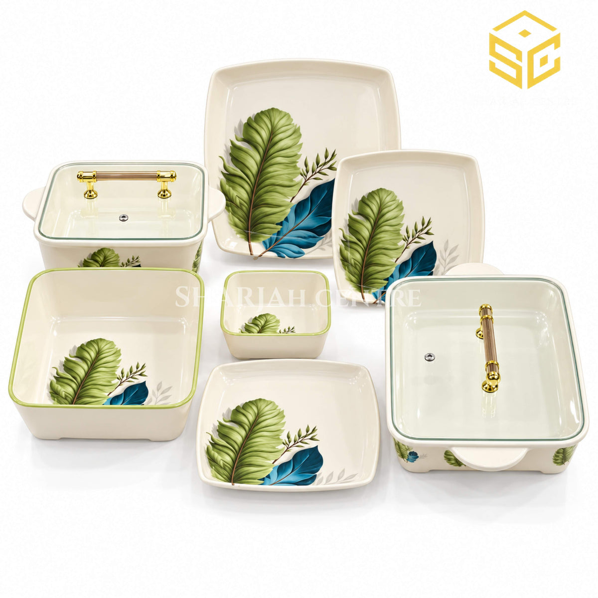 Glamour square dinnerware with green and teal-blue leaves, green-rimmed bowls and clear-lidded serving dishes is displayed against a white background.