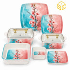Glamour square dinnerware with pink blossoms on turquoise-and-pink backgrounds is displayed with matching bowls and clear-lidded serving dishes.