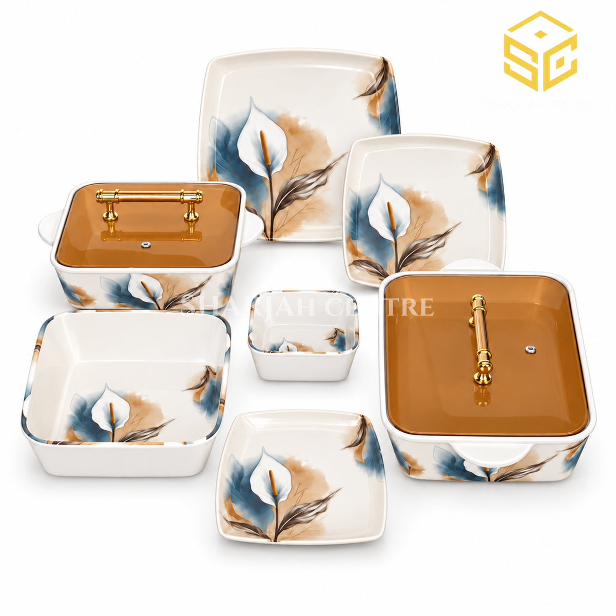 Glamour White Lily plates, bowls and covered serving dishes with gold-tone handles are displayed on a wooden table.
