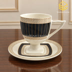ivory black gold cup and saucer, gold lattice pattern, black panel design, pedestal tea cup, luxury wooden table setting, Sharjah Centre Multan