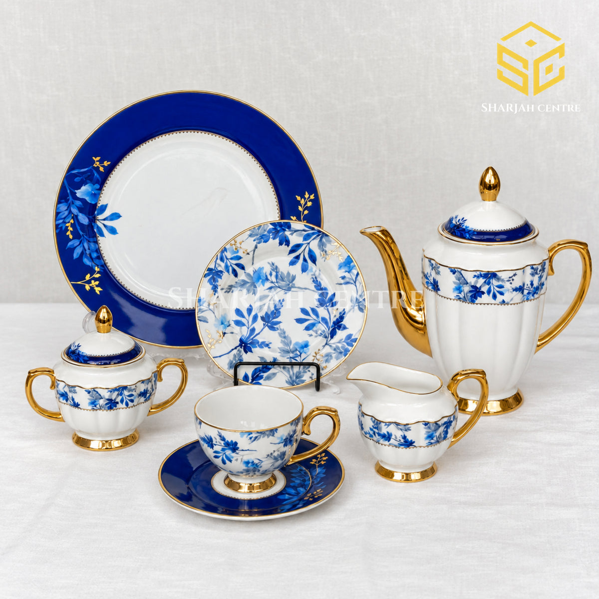 Johanson Bros England 24-piece Super Bone tea set with 6 person serving, cobalt-blue floral design and gold-tone accents white bg