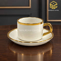 ivory white cup and saucer, gold rim, gold handle, luxury tea crockery, wooden table setting, Sharjah Centre Multan
