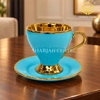Luxury turquoise gold tea cup and saucer on wooden table – Sharjah Centre