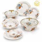 Modern round plates, bowls and covered serving dishes display blue and brown leaf patterns against a white background.