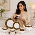 N C England Model 24-piece Super Bone tea set with 6 person serving, black borders and ornate gold-tone detailing model bg