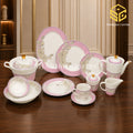 Pink floral fine bone china dinnerware set with gold accents in a luxury interior wooden table
