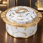 Ornate white marble and gold insulated hotpot displayed in a luxury interior